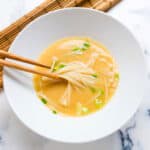 Enoki mushroom soup served in a bowl.