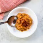 Spicy miso paste being picked up with a spoon.