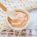 Seafood aioli being scooped out with a spoon.