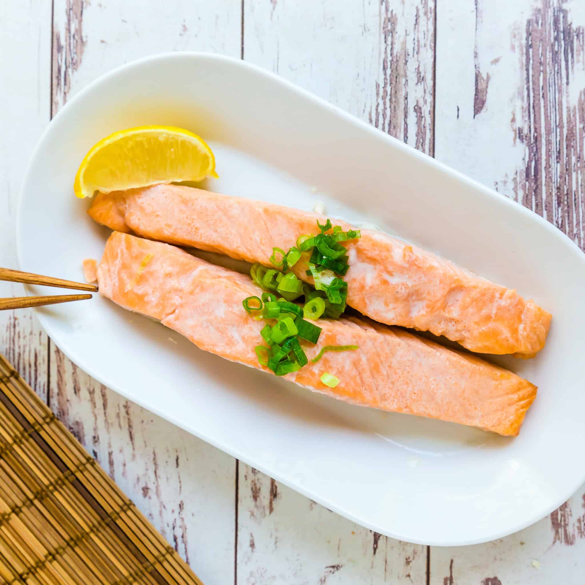 Oven grilled salmon strips are placed on a plate.
