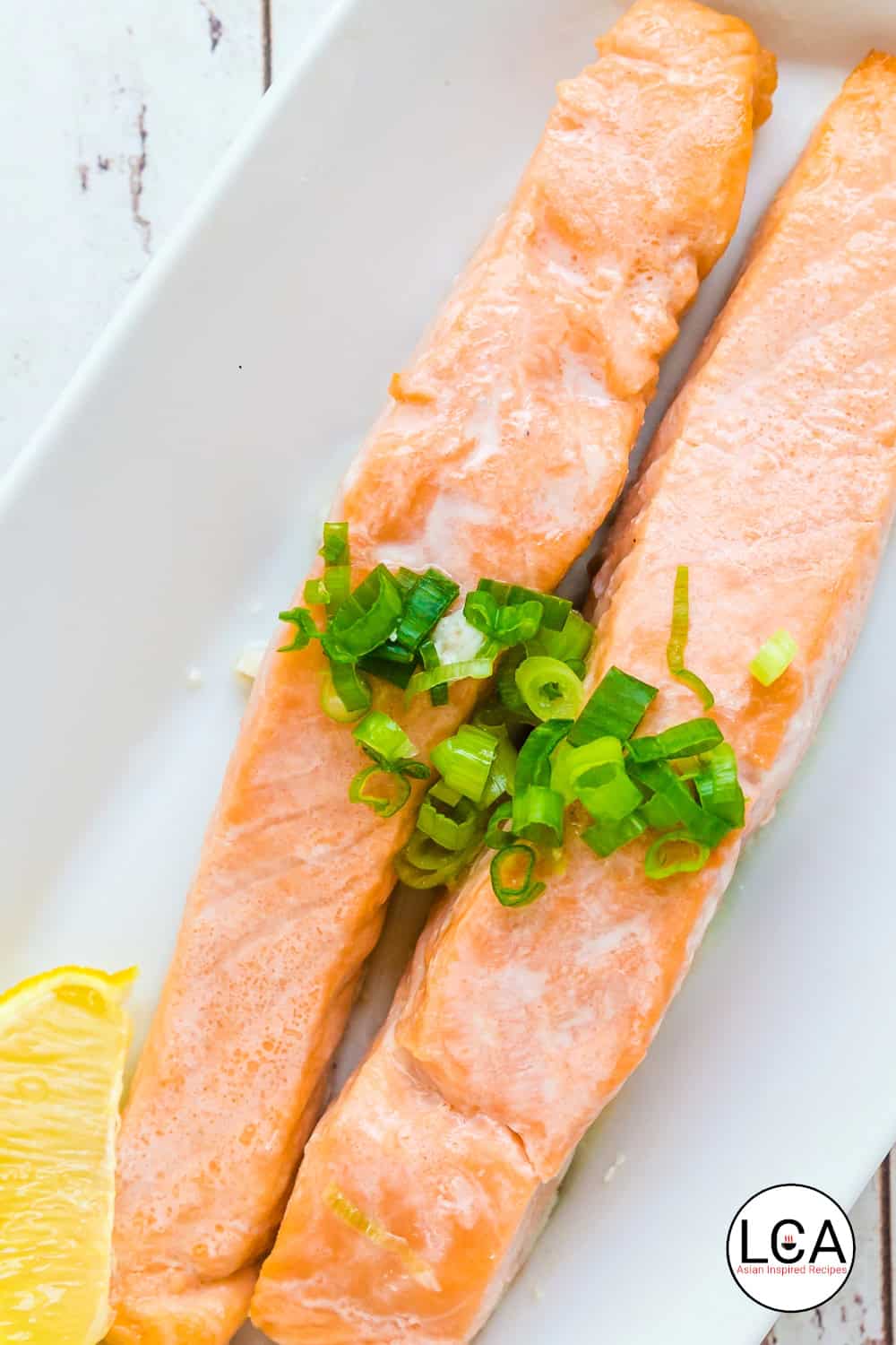 Oven grilled salmon strips are placed on a plate.