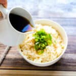 Japanese style rice sauce being drizzled on rice.