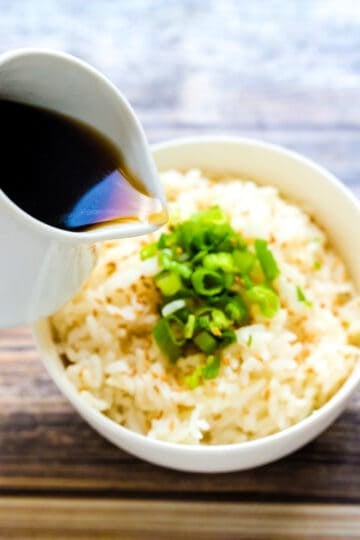 Japanese style rice sauce being drizzled on rice.