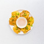 Crab cakes served on a plate with Old Bay aioli dipping sauce.