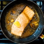 Salmon being cooked in Japanese broth.