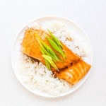 Pan fried glazed teriyaki salmon served on top of rice.