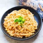 Simmered garlic enoki mushroom served on a plate.