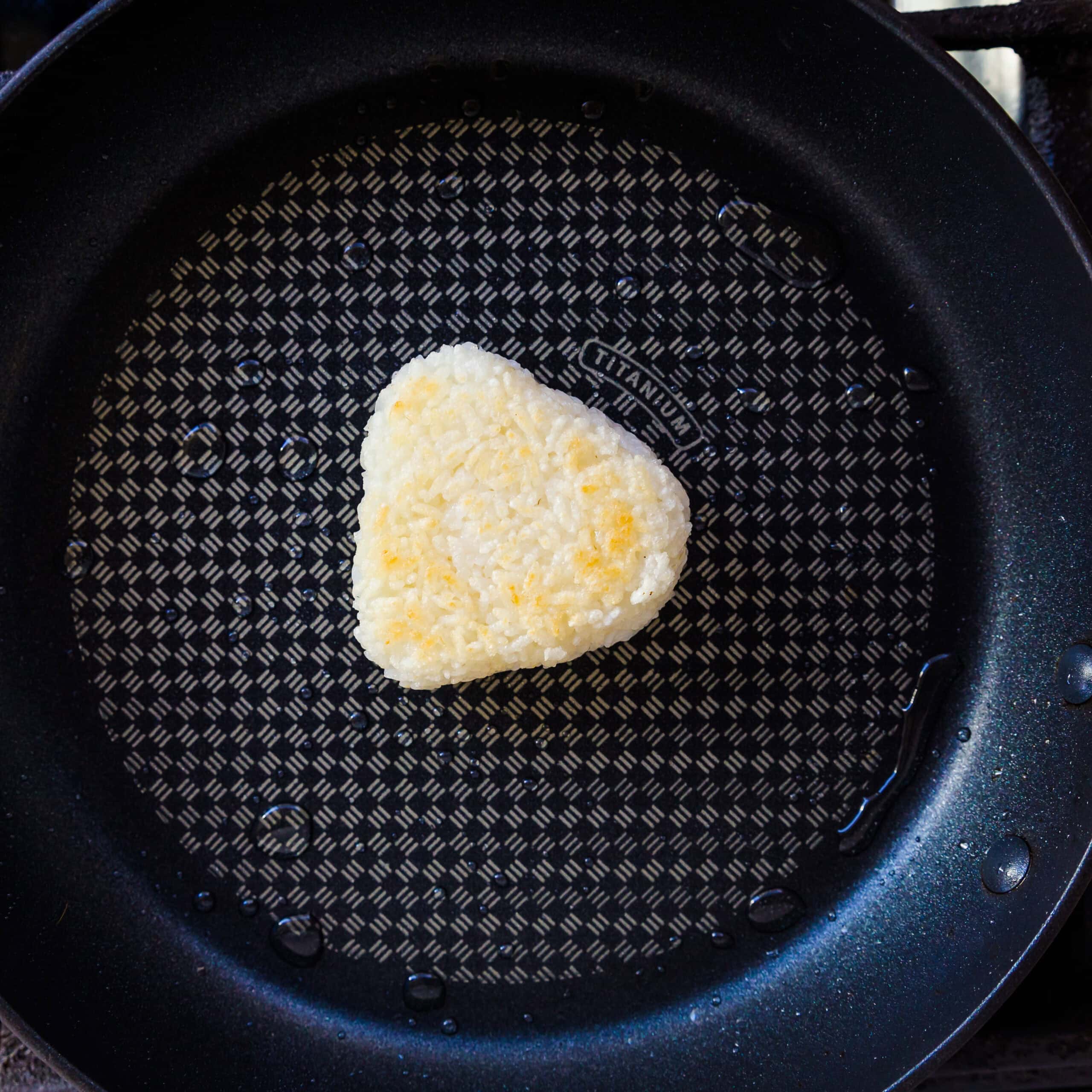 Rice balls bake in a frying pan. 