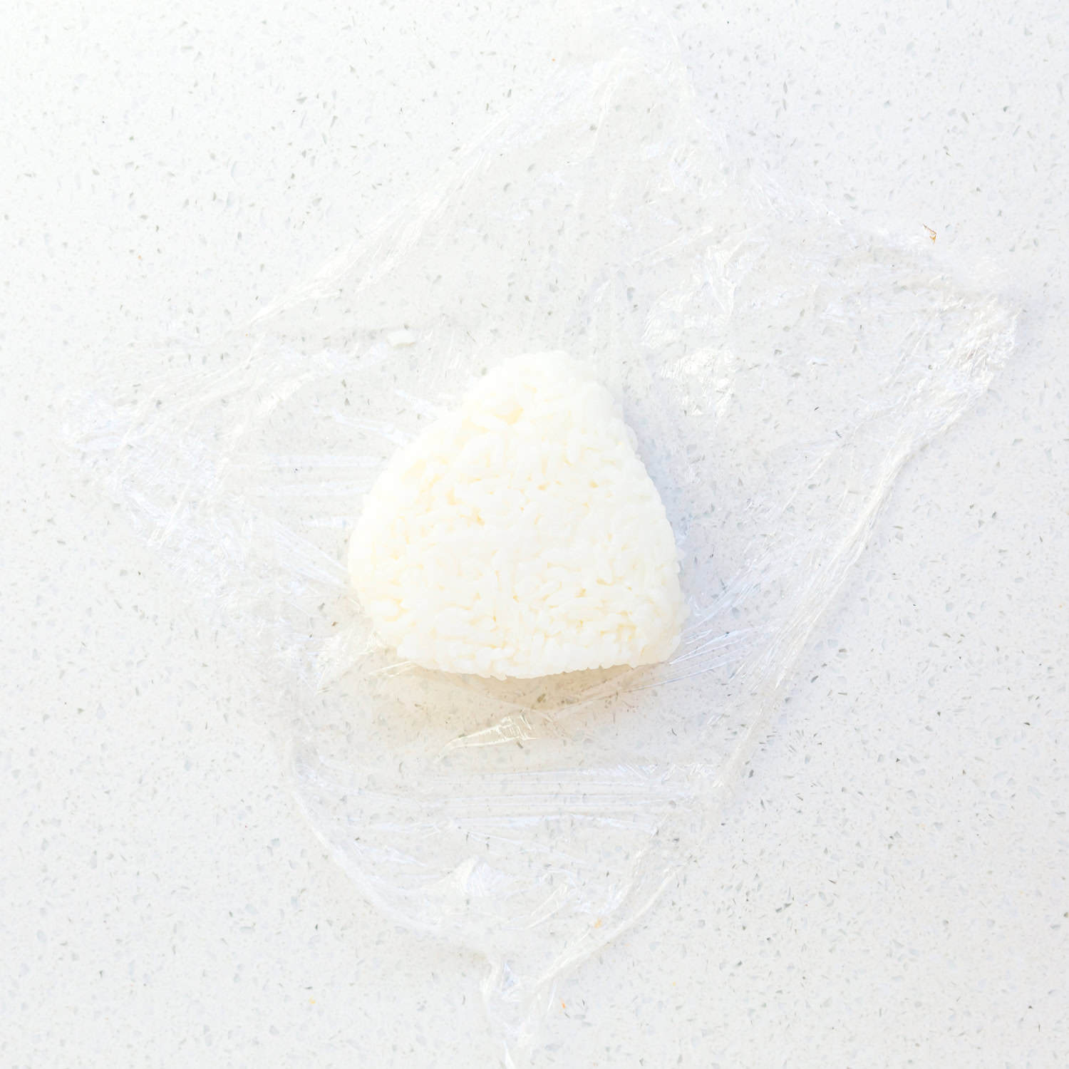 Saran package on the rice ball. 