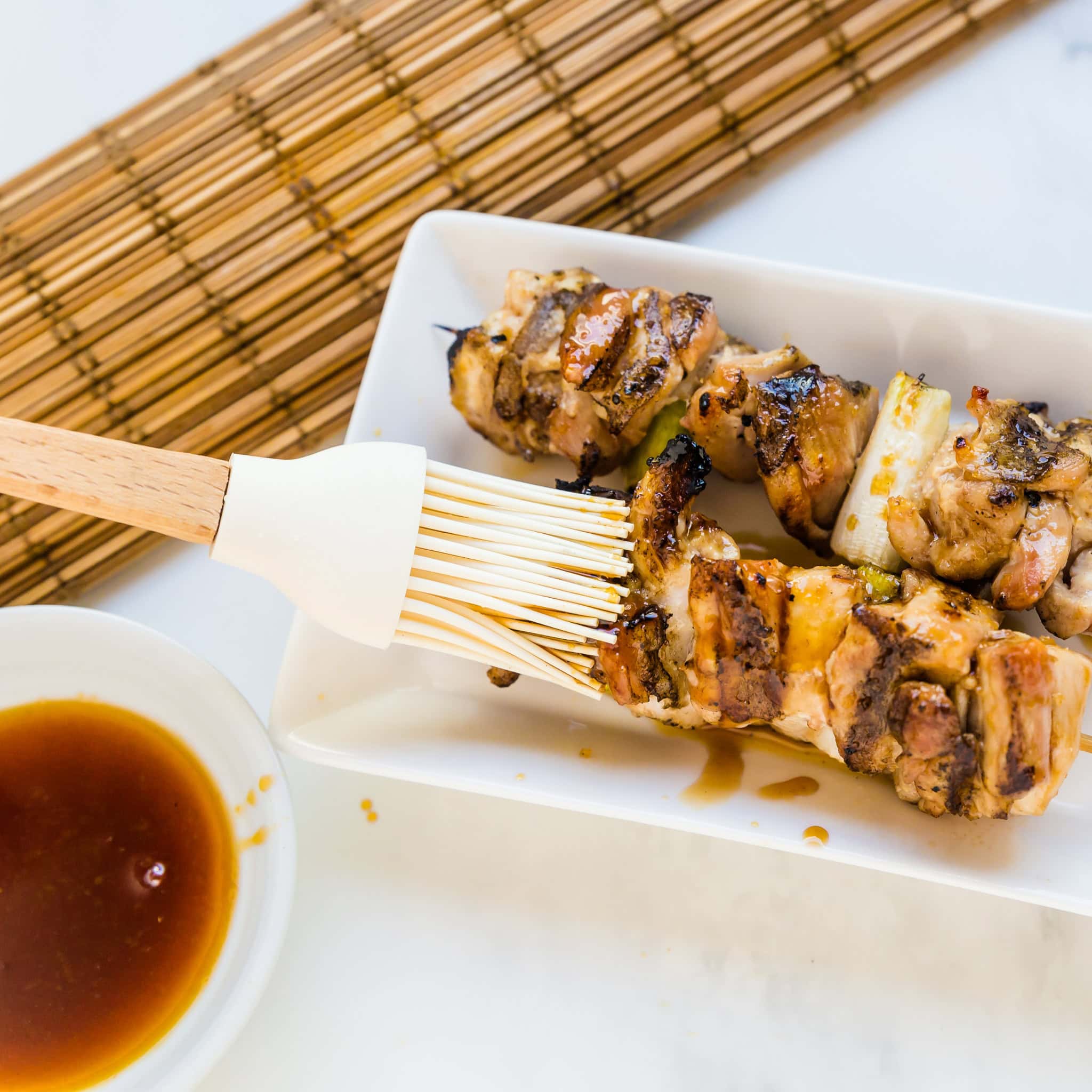 Yakitori sauce brushed on chicken skewers.