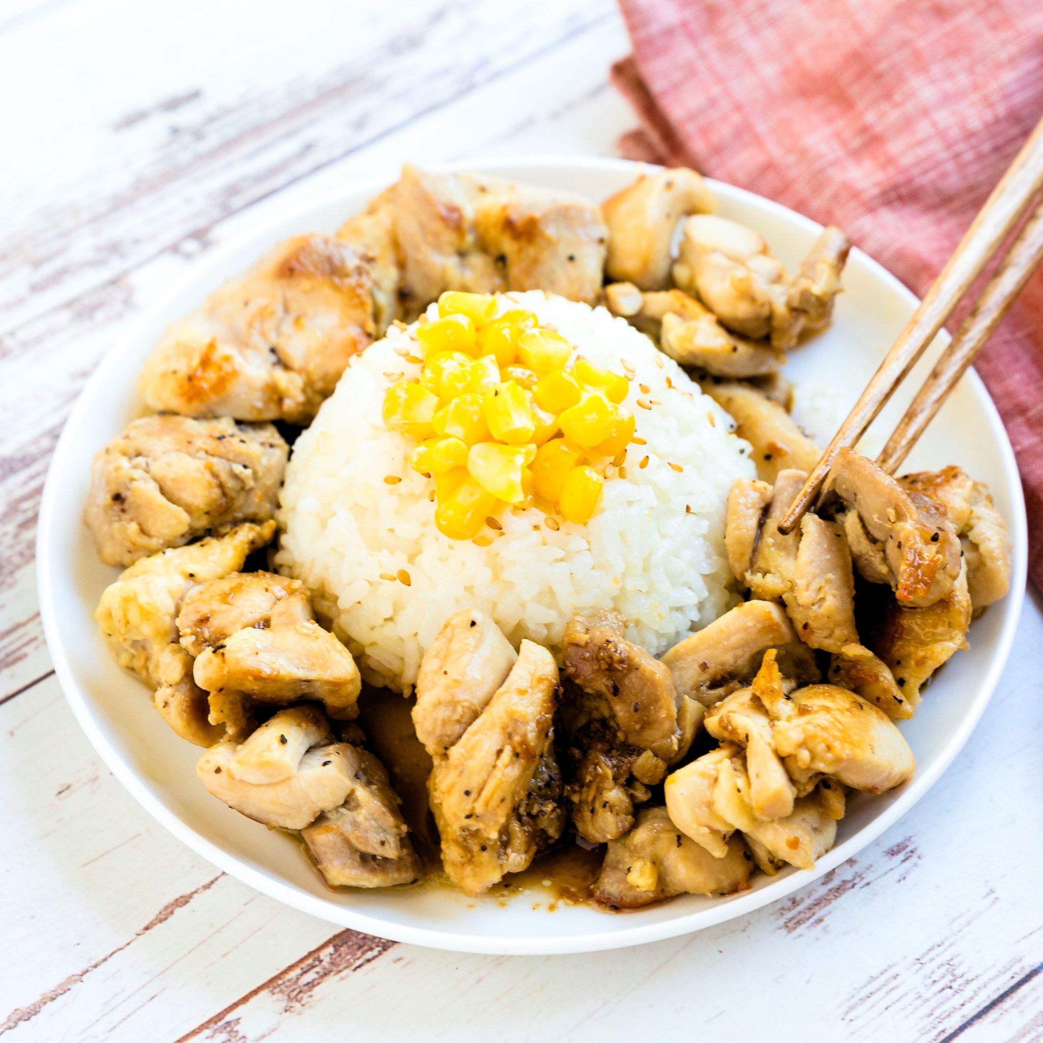 The pepper lunch chicken was picked up with a pair of chopsticks.