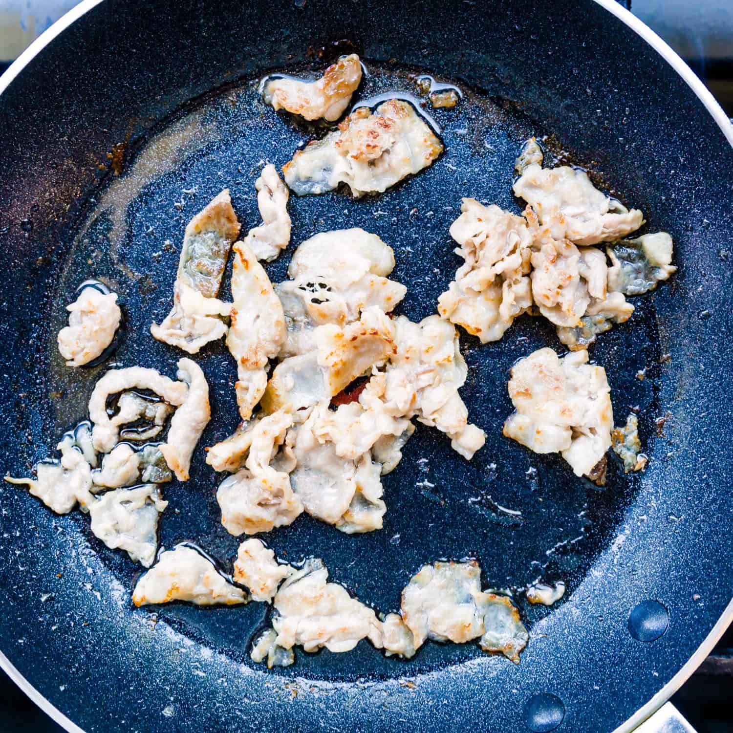 Slice the pork and cook in a pot. 