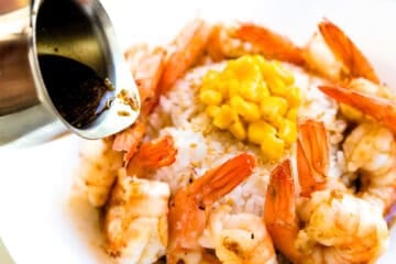 Pepper Lunch sauce being drizzled on shrimp.