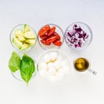 Ingredients to make avocado mozzarella salad on the countertop.